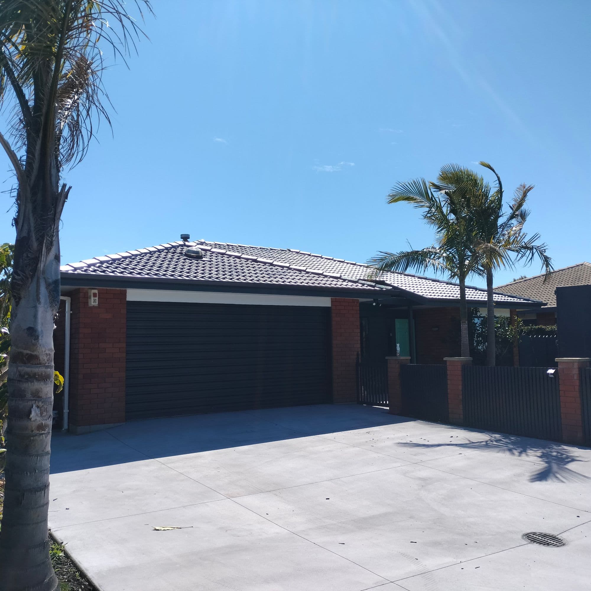 Freshly restored tiled roof on a brick home
